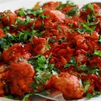 Chicken 65 · Deep fried chicken with punchy flavours Of curry leaves, ginger, garlic and chillies.
