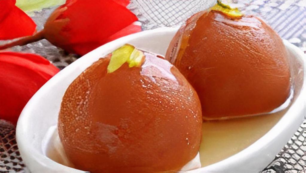 Gulab Jamun · Two deep fried waffle balls soaked in rosewater and honey syrup