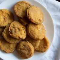 Fried Green Tomatoes · Favorite. Sliced green tomatoes hand rolled in spicy cornmeal and fried to golden brown. Ser...