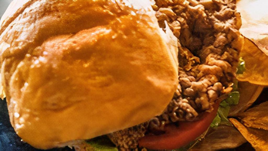 Chicken Fried Steak Sandwich · Chicken fried steak on a toasted bun with lettuce, tomato and mayonnaise.
