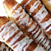 Cinnamon Sugar Breadsticks · Our signature dough covered in cinnamon and sugar baked to perfection and drizzled with icin...