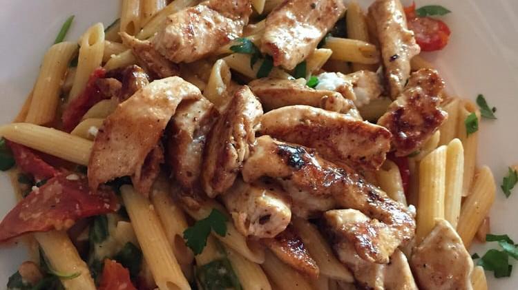 Grilled Chicken Arugula · Grilled chicken, sun-dried tomatoes, pine nuts, white wine garlic sauce, low carb penne pasta, topped with ricotta cheese and arugula.