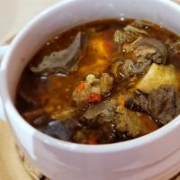 Papper Soup (Large) · Spicy soup made with authentic Nigerian herbs and a combination of meats (goat, cow foot, & ...