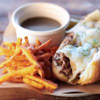 French Dip · Beer - Infused. Shaved ribeye seasoned & seared, caramelized onions, melted swiss cheese & g...