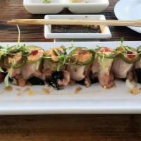The Ultimate Hamachi Roll · Served spicy. Spicy yellowtail, shrimp tempura, avocado, cucumber, sprouts, topped with yell...