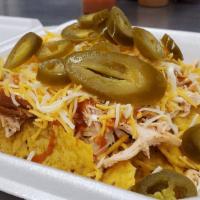 Chopped Brisket Nachos · Juicy, succulent brisket on top of a bed of tortilla chips. Topped with sour cream, shredded...