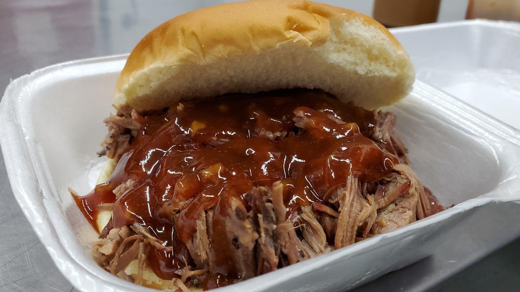 Brisket Sandwich · Smokey and savory chopped brisket on a bun. Served with any sauce of your choice.