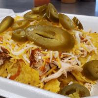 Pulled Pork Nachos · Tender pulled pork on a bed of tortilla chips. Topped with sour cream, shredded cheese, jala...