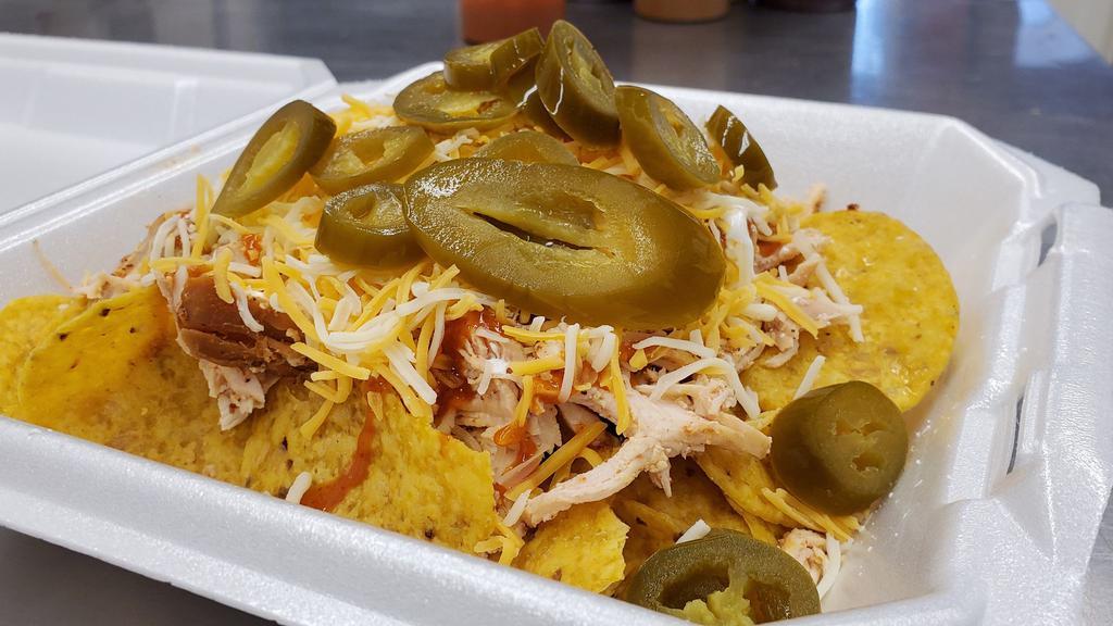 Chicken Nachos  · Smoked, boneless, skinless chicken breast on top of a bed of tortilla chips. Topped with sour cream, shredded cheese, jalapenos, and your choice of sauce.