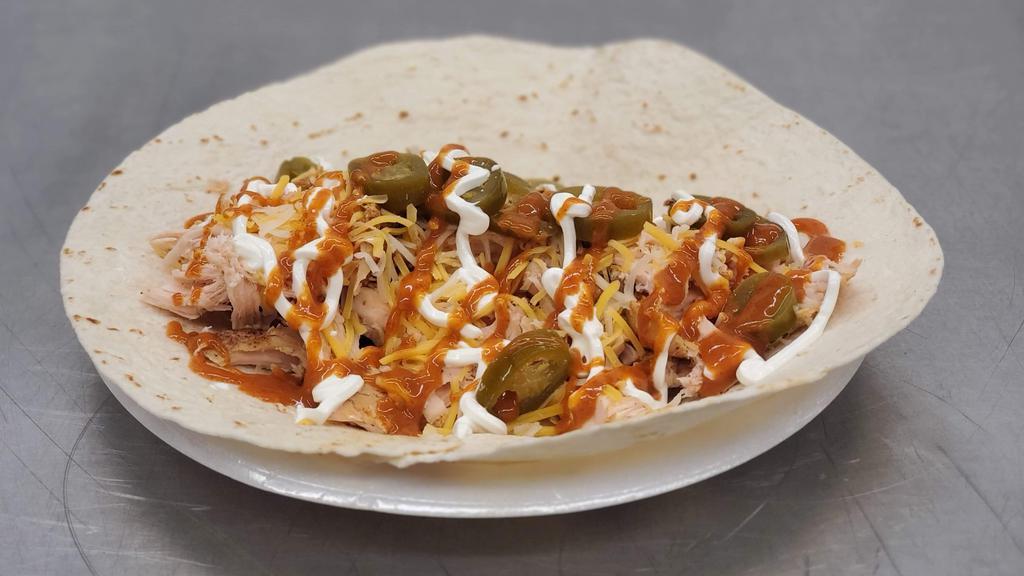 Smoked Chicken Burrito · Smoked, boneless, skinless, Chicken  wrapped up in a warm tortilla shell. Stuffed with sour cream, shredded cheese, jalapenos and your choice of sauce.