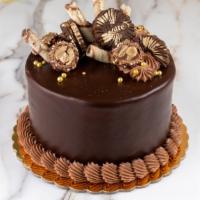 Nutella Hazelnut Cake · Serves six to eight. Chocolate cake with Nutella, hazelnut mousse and toasted hazelnuts.