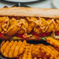 Shrimp Po-Boy · Classic Louisiana po-boy sandwich with fried shrimp, shredded lettuce, tomato, and homemade ...