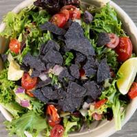 Holy Guacamole · spring mix, avocados, red onions, cherry tomatoes, tortilla chips and a fresh lime wedge ser...
