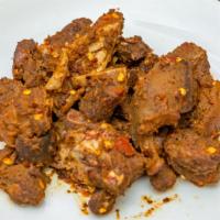 Asun - Charcoal Grilled Goat Meat · Spiced with tomato sauce and onions.
