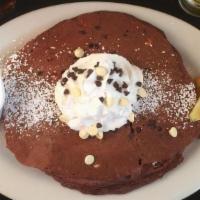 Red Velvet Chocolate Chip Pancakes · white and milk chocolate chips, served with cream cheese syrup. add fresh strawberry, bluebe...
