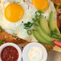 Rise & Shine Chilaquiles · ranchero chips, rojas sauce, refried beans, cheddar & cotija cheese, two eggs any-style, avo...