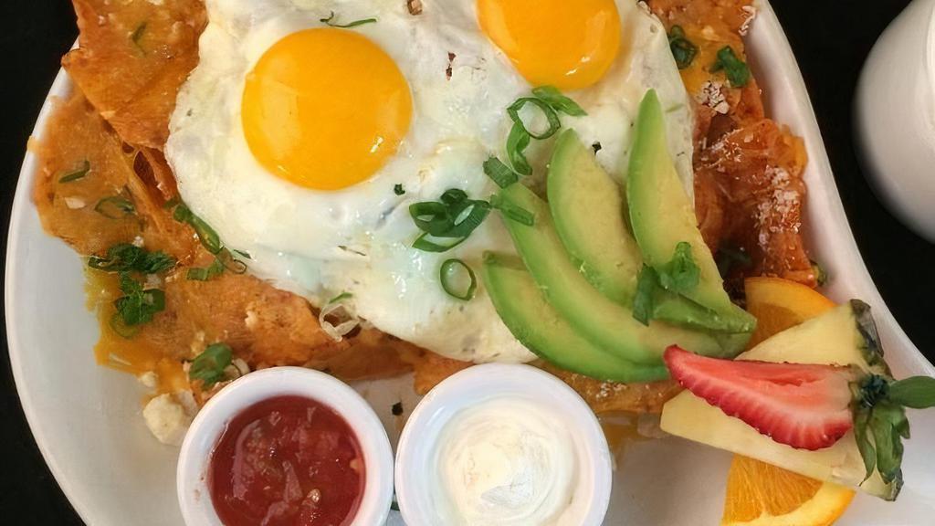 Rise & Shine Chilaquiles · ranchero chips, rojas sauce, refried beans, cheddar & cotija cheese, two eggs any-style, avocado, green onion, salsa & sour cream