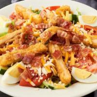 Country Chicken Salad · Breaded chicken breast over a bed o mixed lettuce, tomatoes, cucumbers, red onions, cheddar ...