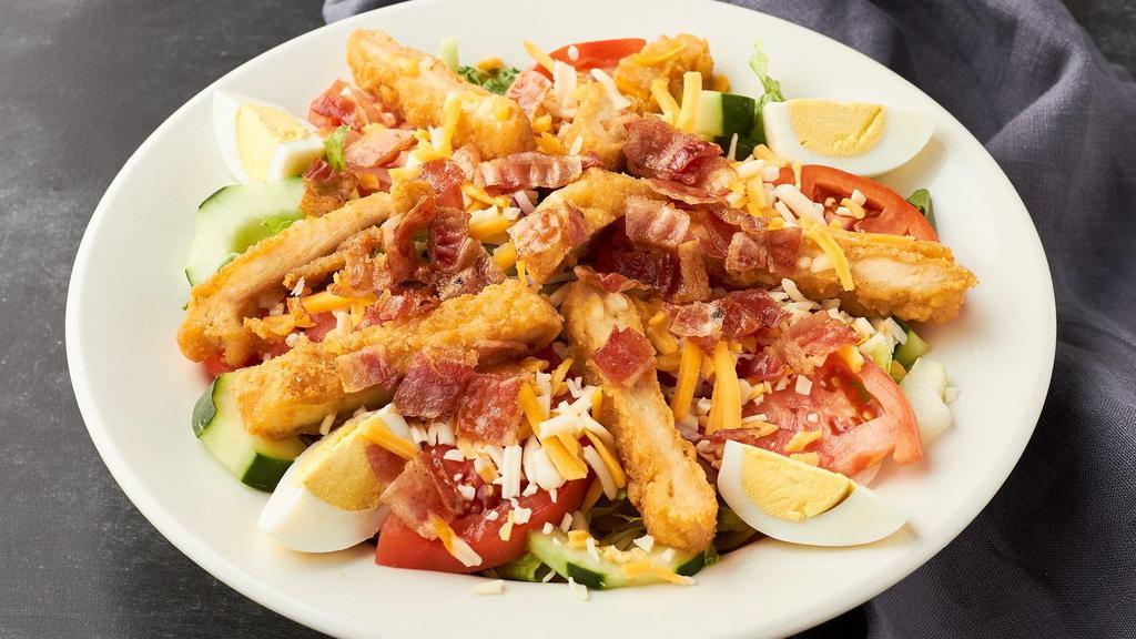 Country Chicken Salad · Breaded chicken breast over a bed o mixed lettuce, tomatoes, cucumbers, red onions, cheddar jack cheese, bacon and boiled eggs.