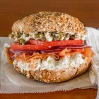 Loxness Monster Bagel · Fresh smoked lox, sliced tomato, red onion, capers, and cucumber dill spread on a bagel.