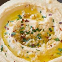 Roasted Garlic Hummus · Chickpeas, roasted garlic, lemon and tahini blended to perfection served with pita bread, cu...
