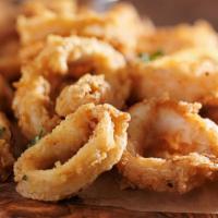 Fried Calamari Al Jalapeño · Lightly floured with banana rings, saute in an herb butter with white wine.