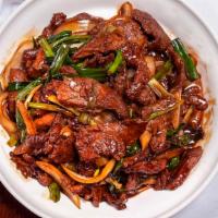 Mongolian Beef · Sliced tender flank steak sautéed with onions and scallions in a Northern style stir-fry