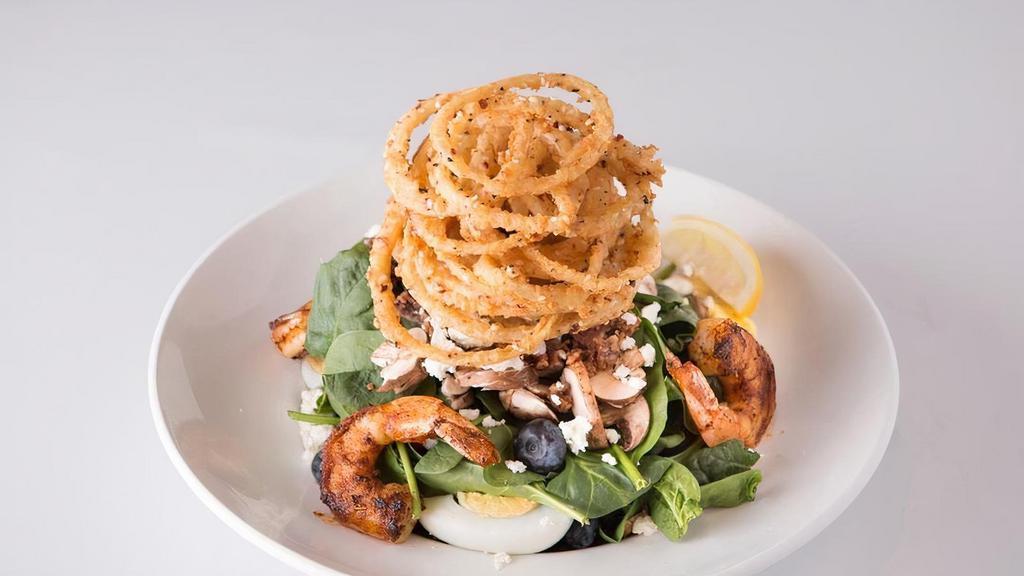 Blackened Shrimp Spinach Salad · Blackened shrimp over fresh spinach, bacon, sliced mushrooms, boiled eggs, . feta cheese, crispy onion strings and fresh blueberries, with warm bacon-brown sugar dressing.