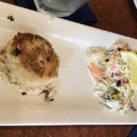 Lump Blue Crab Cakes · Sautéed lump blue crab cakes, . served with Cajun remoulade, . rice pilaf and zesty coleslaw.