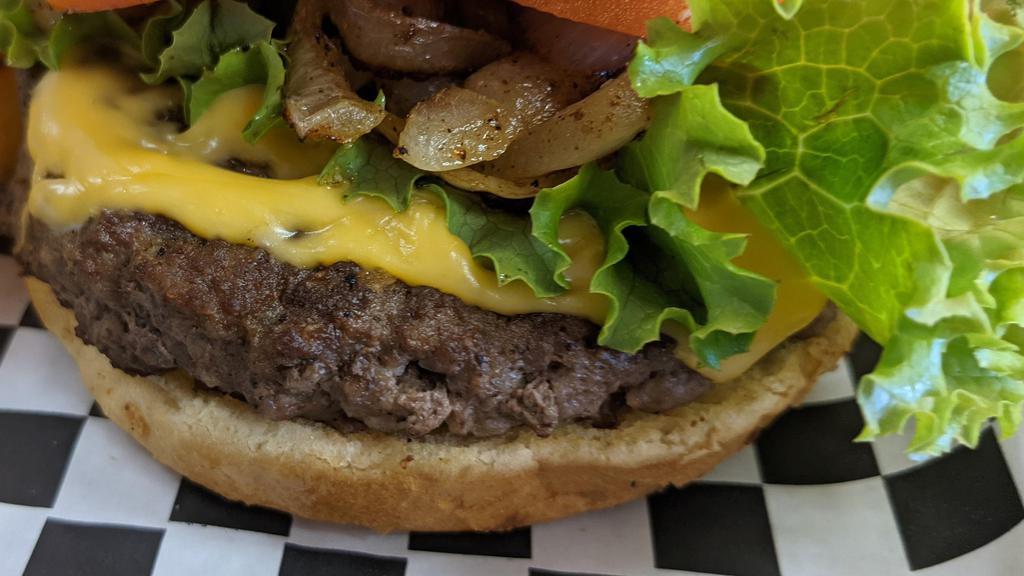 Grande Burger · A half-pound angus beef patty on Sweet Hawaiian buns. Includes cheese, fresh lettuce, sliced tomatoes, pickles, grilled onions, and mayo/mustard packet