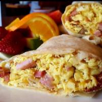 Breakfast Burrito · Flour tortilla filled with two scrambled eggs, bacon, sausage, ham and cheddar cheese. All i...