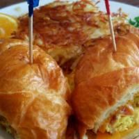 Egg Croissant · Choice of ham, bacon or sausage with cheese and two scrambled eggs. All items are served wit...