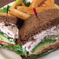 Turkey Avocado Sandwich · Thinly sliced breast of turkey and ripe avocado with lettuce, tomato, cucumber slices and al...