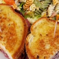 Reuben Sandwich · Tender corned beef, Swiss cheese and sauerkraut grilled on rye bread. Served with potato sal...