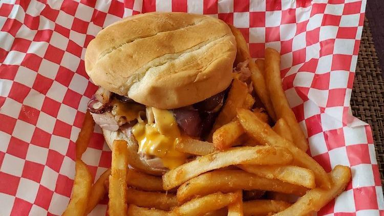Big Nate'S Special · Choice of smoked chicken, brisket or pork piled high on a toasted bun. Smothered with choice of cheese and topped with grilled onions.