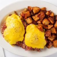 Traditional Eggs Benedict · Traditional eggs benedict with Canadian bacon served over toasted English muffin and home fr...