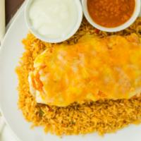 Pollo Guisado Burrito · With Ranchera Sauce. Stuffed with Rice, Black Beans, Monterey Jack and Cheddar, Topped with ...