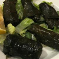 Dolma · Stuffed grape leaves. Marinated grape leaves filled with mixture of rice, onion and herbs.