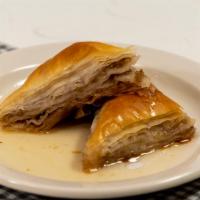Baklava · Flakey pastry triangles filled with crushed walnuts and soaked in syrup.