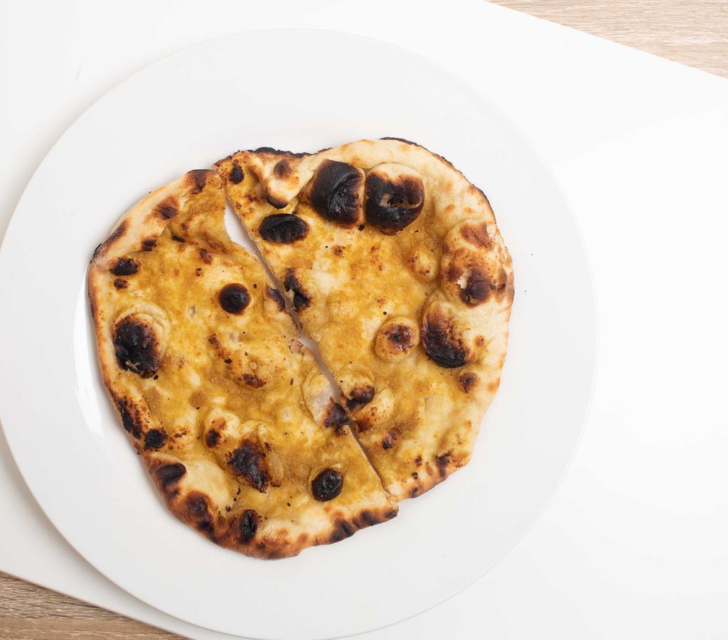 Garlic Naan · Leavened bread with roasted garlic and butter.