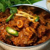 Goat Karahi · Small pieces of goat meat cooked in special spices. Includes 2 naans