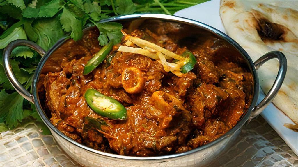 Goat Karahi · Small pieces of goat meat cooked in special spices. Includes 2 naans