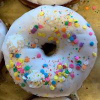 Cake Batter Donut · Large yeast ring donut with housemade cake batter glaze, buttercream dollops, and pastel seq...