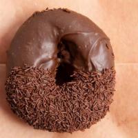 Triple Chocolate Threat Donut · Chocolate cake donut with housemade chocolate glaze half dipped in chocolate sprinkles