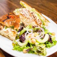 Turkey Pesto Sandwich · Homemade focaccia with cherry tomatoes and rosemary served with pesto, turkey slices, and Me...