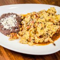 Huevos Machacados · Norteno style scrambled eggs with Mexican dried beef, pico de gallo on a bed of roasted toma...