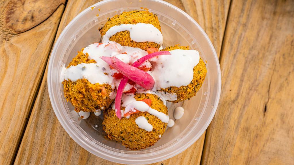 Falafel · A deep-fried ball patty, made from ground chickpeas, herbs and spices, served with basmati rice, veggies, feta cheese, tzatziki and pita bread.
