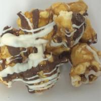 Drizzled Delight Popcorn · Caramel popcorn with milk and white chocolate drizzled all over.