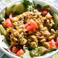 Curry Chicken Salad · Mixed baby greens, tomatoes, cucumbers and our curry chicken salad tossed with our balsamic ...