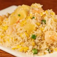 Thai Pineapple Fried Rice · Stir-fried jasmine rice, vegetables, choice of protein, and fresh pineapple in white Thai sa...